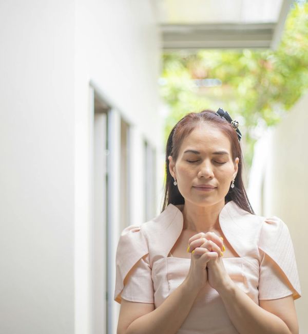 Person meditating peacefully with a calm expression.